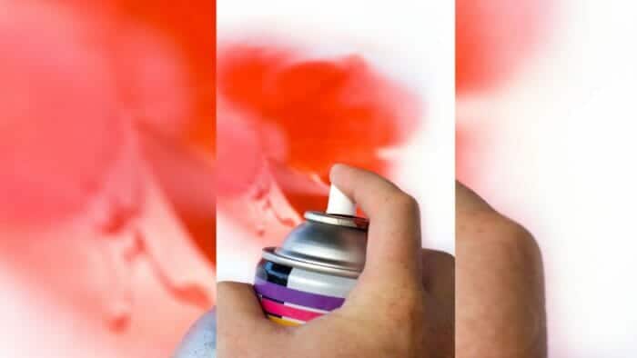 closeup of spray paint being used to paint a plastic surface