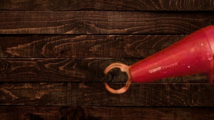 a hairdryer being used to remove a water stain on wood