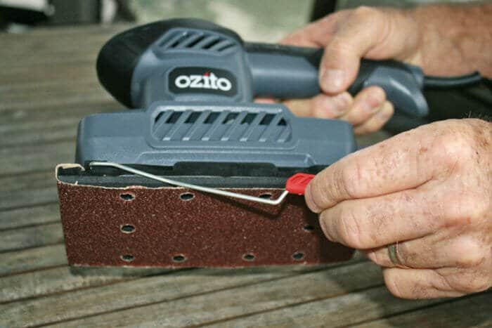 attaching sandpaper to a sheet sander