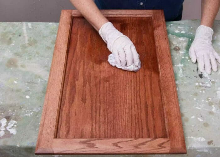 staining the door of a wooden cabinet
